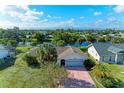 Captivating overhead view of a well-maintained home near a scenic lake at 3381 Conway Blvd, Port Charlotte, FL 33952