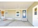 Covered front entrance with blue accent door, showcasing a clean, well-maintained exterior at 37530 Corey Lewis Ave, Zephyrhills, FL 33541