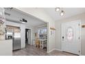 Bright entryway featuring wood floors, a stylish door, and an adjacent kitchen area at 4750 Burlington N Ave, St Petersburg, FL 33713