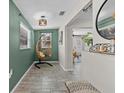 Cozy hallway featuring a unique hanging chair, stylish decor, and natural light at 4750 Burlington N Ave, St Petersburg, FL 33713