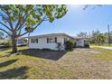 Charming single-story home with a well-maintained lawn and mature trees at 5167 Venetian Ne Blvd, St Petersburg, FL 33703
