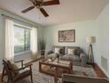Comfortable living room with fan, couch, and window offering natural light at 9037 Pebble Creek Dr, Tampa, FL 33647