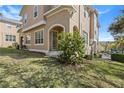 Charming townhouse with lush green lawn, flowering shrub and classic design at 94 S Highland Ave # 2402, Tarpon Springs, FL 34689