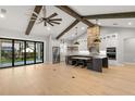 Bright, open kitchen featuring beamed ceilings, a large island, and modern stainless appliances at 0 Old Country Rd, Odessa, FL 33556