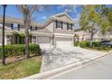 Charming two-story townhome with an attached two-car garage, lovely landscaping, and a concrete driveway at 11240 Windsor Place Circle Cir, Tampa, FL 33626