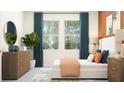 Bright bedroom featuring large windows, modern furniture, and stylish decor at 11853 Sparkling Topaz Cv, Parrish, FL 34219
