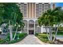 Elegant condo entrance with stone accents, lush landscaping, and easy access at 1270 Gulf Blvd # 506, Clearwater Beach, FL 33767
