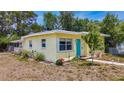 Quaint yellow home showcasing lovely landscaping and a welcoming front entrance at 1679 29Th N Ave, St Petersburg, FL 33713