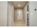 Inviting foyer with tile flooring, closet space, and neutral paint, creating a clean, welcoming atmosphere at 1721 Sutton Pl, Dunedin, FL 34698