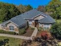 Aerial view of the lovely single-story home, showcasing the roof, landscaping, and surrounding trees at 19719 Prince Benjamin Dr, Lutz, FL 33549
