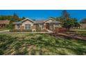 Charming single-story home with stone accents, lush landscaping, and a well-manicured lawn at 19719 Prince Benjamin Dr, Lutz, FL 33549