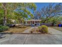 Charming one-story house with a inviting front porch and well-maintained lawn at 2340 Kingston S St, St Petersburg, FL 33711