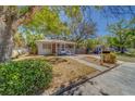 Quaint one-story house with a cozy porch and a green bush in the yard at 2340 Kingston S St, St Petersburg, FL 33711
