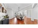 Elegant dining room featuring hardwood floors, large windows, and a sophisticated chandelier at 2706 Colewood Ln, Dover, FL 33527