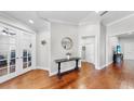 Inviting foyer with hardwood floors, elegant console table, and charming decor at 2706 Colewood Ln, Dover, FL 33527