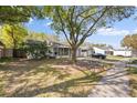 Street view of a quaint single-story home with a pergola over the entry and a well-manicured front lawn at 2906 Cedaridge Dr, Tampa, FL 33618