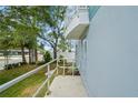 Exterior shot of a sidewalk leading to a door with a safety handrail and tropical landscaping at 3405 W Swann Ave # 9, Tampa, FL 33609