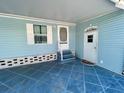 Exterior carport entry with blue flooring, vinyl siding and painted trim at 34510 Rose N Dr, Pinellas Park, FL 33781