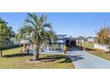 Well-maintained single-story home with mature landscaping, patio, and carport at 37235 Cora Ave, Zephyrhills, FL 33542