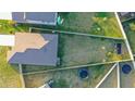 Aerial view of a fully fenced backyard with well-maintained grass and play equipment at 5412 Olano St, Palmetto, FL 34221