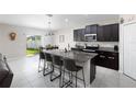 Modern kitchen featuring an island with seating and a stainless steel sink at 5412 Olano St, Palmetto, FL 34221