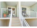 Inviting condo balcony with comfortable seating, scenic neighborhood views, and nautical décor at 545 Bahia Beach Blvd, Ruskin, FL 33570