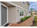 Beautiful townhome featuring manicured landscaping, a brick walkway, and a gray front door at 5728 Skytop Dr, Lithia, FL 33547