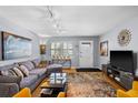 Inviting living room with cozy gray couch, contemporary decor, and plenty of natural light at 5840 30Th S Ave # 305, Gulfport, FL 33707