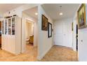 Tiled hallway with white walls and white trim with doorways to bathroom and kitchen at 628 Cleveland St # 907, Clearwater, FL 33755