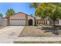 Well-maintained single-story home with stone accents, double-door entry, manicured lawn, and attached two-car garage at 8329 Broken Willow Ln, Port Richey, FL 34668