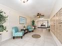 Inviting lobby area with stylish seating, tiled flooring, and mailboxes for residents at 100 Bluff View Dr # 317A, Belleair Bluffs, FL 33770