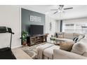 Stylish living room features a neutral color palette, plush sectional sofa, and a contemporary entertainment center at 10105 Paradise Fish Dr, Riverview, FL 33578