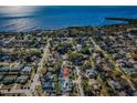 Expansive aerial shot offering panoramic views of the neighborhood, ocean, and surrounding lush greenery at 1017 Jamaica Way, Tarpon Springs, FL 34689