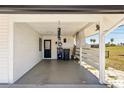 Covered carport featuring a concrete floor, access door, and partial fencing, providing sheltered parking at 1021 Augusta Dr, Sun City Center, FL 33573