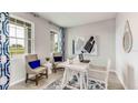 Bright home office featuring a modern desk, stylish decor, and large windows offering scenic views at 10559 Farm Hill Ave, Land O Lakes, FL 34638