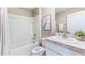 The clean bathroom boasts a shower-tub combo, granite vanity, and neutral decor for a comfortable experience at 10597 Dusty Boot Rd, Land O Lakes, FL 34638