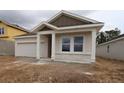 Charming single-story home featuring stucco siding, a two-car garage, and a welcoming front porch at 10640 Crescent Creek Xing, Parrish, FL 34219