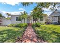 Charming home featuring a brick walkway, well-manicured lawn, and inviting landscaping at 1235 14Th N St, St Petersburg, FL 33705