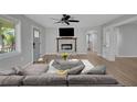 Cozy living room with a stone fireplace, ceiling fan, and modern decor at 1235 14Th N St, St Petersburg, FL 33705