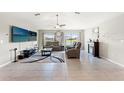 Bright living room with vaulted ceiling, tile flooring, neutral walls, fireplace, and comfortable seating at 13538 Willow Bluestar Loop, Riverview, FL 33579