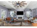 Bright living room featuring hardwood floors, a ceiling fan, fireplace, and built-in shelving showcasing decorative items at 2005 Jackson N St, St Petersburg, FL 33704