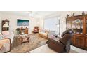 Cozy living room with plush seating, entertainment center, and bright natural light at 2009 Halidom Way, Sun City Center, FL 33573