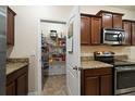 Kitchen view with a large pantry filled with storage; granite countertops and stainless steel appliances at 2011 Hawks View Dr, Ruskin, FL 33570