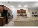 Bright kitchen features granite countertops, stainless steel appliances, and a large island with a sink at 2011 Hawks View Dr, Ruskin, FL 33570