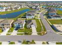 Wide aerial shot capturing a neatly planned community with ponds, lush lawns, and evenly spaced homes at 31399 Penny Surf Loop, Wesley Chapel, FL 33545
