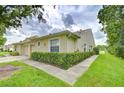 Well-maintained villa exterior with tidy landscaping, enhancing curb appeal at 34907 Double Eagle Ct, Zephyrhills, FL 33541