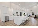 Bright kitchen boasts stainless appliances, white cabinets, a center island with seating, and an open floor plan at 3860 Whiting Se Dr, St Petersburg, FL 33705