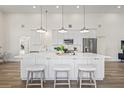 Bright kitchen boasts a large island with seating, stainless appliances, and recessed lighting at 3860 Whiting Se Dr, St Petersburg, FL 33705