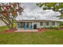 Backyard patio with seating, grill, and sliding glass doors to the home's interior at 401 Dorchester Pl # 69, Sun City Center, FL 33573