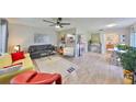 Bright and open living room with modern furniture and decor, connecting to the kitchen and dining area at 401 Dorchester Pl # 69, Sun City Center, FL 33573